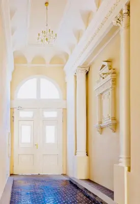 an empty hallway with a white door and a chandelier at New Design apartment right next Wenceslas Square in Prague