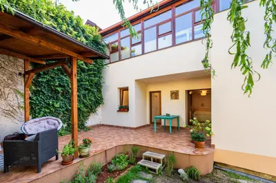 an internal courtyard of a house with a green wall at Apartman u Rudolfa II in Brandýs nad Labem-Stará Boleslav