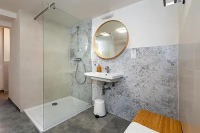 a bathroom with a shower and a sink and a mirror at Apartman u Rudolfa II in Brandýs nad Labem-Stará Boleslav