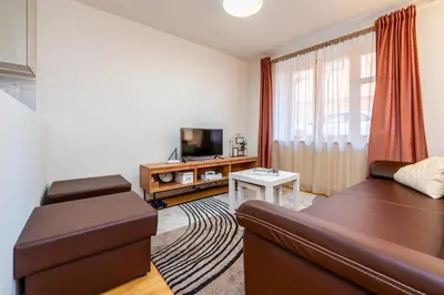 a living room with a couch and a tv at Apartman u Rudolfa II in Brandýs nad Labem-Stará Boleslav