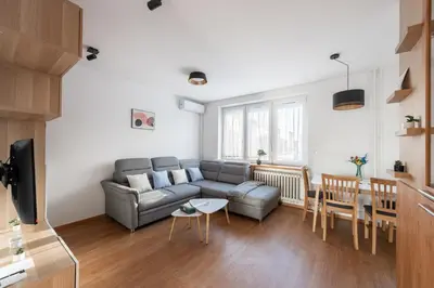 a living room with a couch and a table at All-in 2 Bedroom Family Apartment in Prague