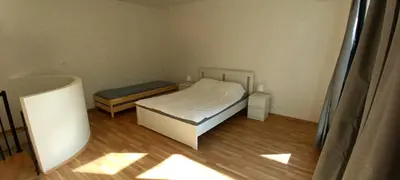 a small bedroom with a bed and a bench at Brand new two room apartment #25 in Elite residence close to center in Prague