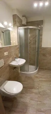 a bathroom with a shower and a toilet and a sink at Brand new two room apartment #25 in Elite residence close to center in Prague
