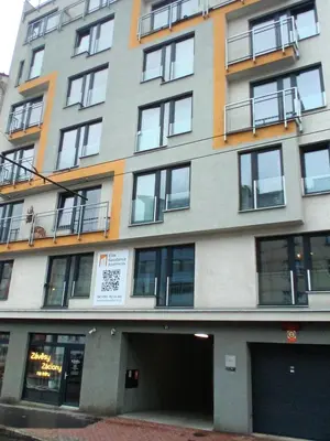 a tall building with windows and a person on a balcony at Brand new two room apartment #25 in Elite residence close to center in Prague