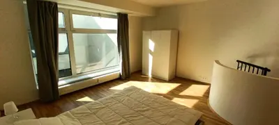 a room with a bed and a large window at Brand new two room apartment #25 in Elite residence close to center in Prague