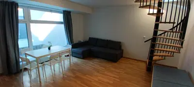 a living room with a staircase and a couch and a table at Brand new two room apartment #25 in Elite residence close to center in Prague