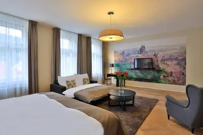 a hotel room with two beds and a tv at James Hotel & Apartments in Prague