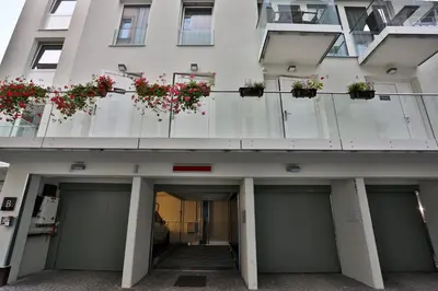 a building with doors and potted plants on it at James Hotel & Apartments in Prague