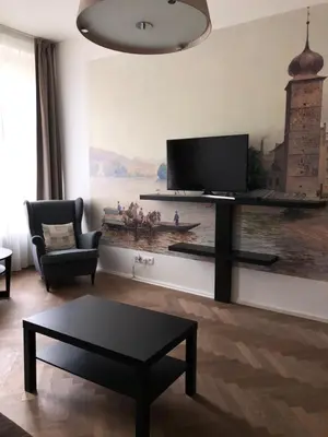 a living room with a flat screen tv on a wall at James Hotel & Apartments in Prague