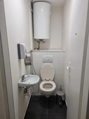 a small bathroom with a toilet and a sink at Hostel Relax in Prague