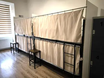 a curtain in a room with a table and a chair at Hostel Relax in Prague