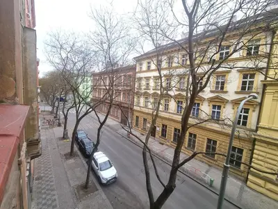 a white car parked on a city street with buildings at Hostel Relax in Prague