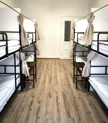 a room with bunk beds and a wooden floor at Hostel Relax in Prague