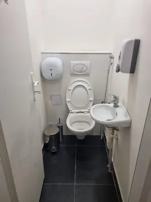 a small bathroom with a toilet and a sink at Hostel Relax in Prague