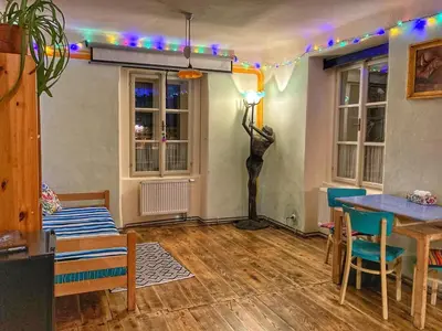 a living room with a table and chairs and lights at Casa Mexico in Roztoky