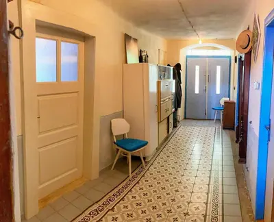 a kitchen with a refrigerator and a table and a chair at Casa Mexico in Roztoky
