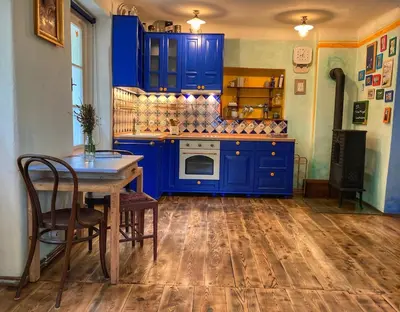 a blue kitchen with a table and blue cabinets at Casa Mexico in Roztoky