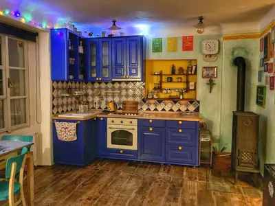 a kitchen with blue cabinets and a stove at Casa Mexico in Roztoky