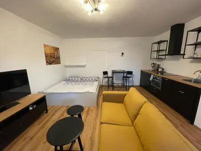 a living room with a couch and a bed at New Apartment near to Elbe bicycle path in Roudnice nad Labem