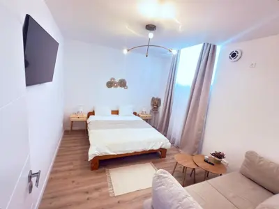 a small bedroom with a bed and a couch at Cosy Cave Station in Prague 5 in Prague