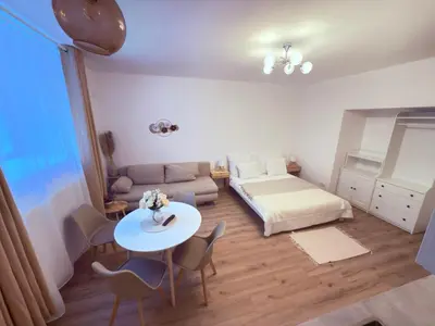 a living room with a bed and a table and chairs at Cosy Cave Station in Prague 5 in Prague