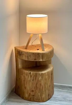a table made out of logs with a lamp on it at Apartmány Křivoklát in Křivoklát