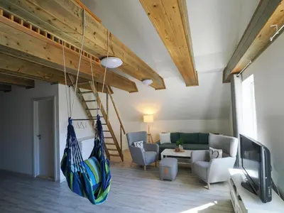 a living room with a hammock hanging from the ceiling at Apartmány Křivoklát in Křivoklát