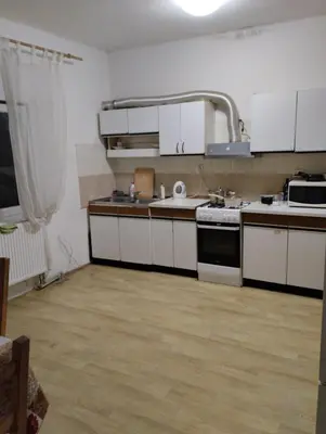 a kitchen with white cabinets and a stove top oven at Sleep & Go Czech Republic - Praha - západ in Jeneček