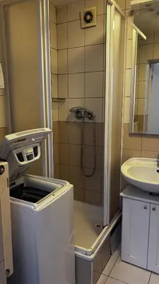 a small bathroom with a shower and a sink at Sleep & Go Czech Republic - Praha - západ in Jeneček