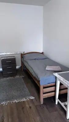 a bedroom with a bed and a desk and a table at Sleep & Go Czech Republic - Praha - západ in Jeneček