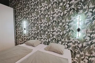 a bedroom with a bed with a floral wallpaper at Contemporary Zizkov Studio -001- in Prague