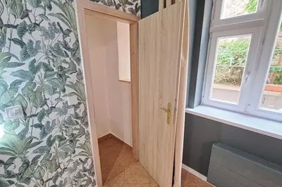 a door in a room with a window and a wall at Contemporary Zizkov Studio -001- in Prague