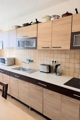 a kitchen with a table and a window in it at Sleep & Go Czech Republic - Velké Popovice in Velké Popovice