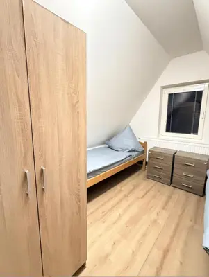 a small bedroom with a bed and a window at Sleep & Go Czech Republic - Kralupy nad Vltavou in Mikovice