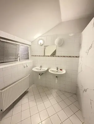 a bathroom with two sinks and a mirror at Sleep & Go Czech Republic - Kralupy nad Vltavou in Mikovice