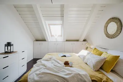 a bedroom with a bed with a teddy bear on it at Prague Days - Attic Maisonette with Netflix and Workspace in New Town in Prague