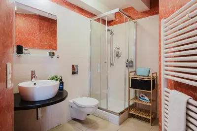 a bathroom with a sink toilet and a shower at Prague Days - Attic Maisonette with Netflix and Workspace in New Town in Prague