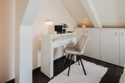a desk with a chair and a computer in a room at Prague Days - Attic Maisonette with Netflix and Workspace in New Town in Prague