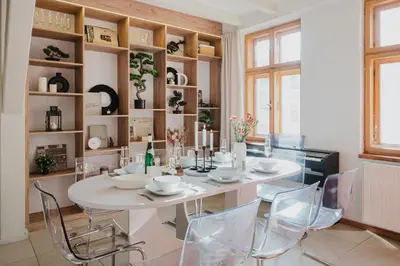 a dining room with a white table and chairs at Prague Days - Attic Maisonette with Netflix and Workspace in New Town in Prague