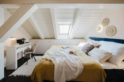 a bedroom with a bed and a desk in a attic at Prague Days - Attic Maisonette with Netflix and Workspace in New Town in Prague