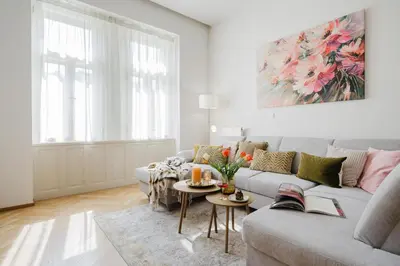 a living room with a couch and a table at Prague Days - Two-bedroom Apartment with Parking Space and 2 bathrooms in Vinohrady in Prague