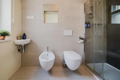 a bathroom with a toilet and a sink and a shower at Prague Days - Two-bedroom Apartment with Parking Space and 2 bathrooms in Vinohrady in Prague