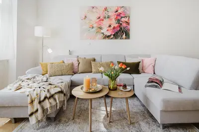 a living room with a couch and a table at Prague Days - Two-bedroom Apartment with Parking Space and 2 bathrooms in Vinohrady in Prague