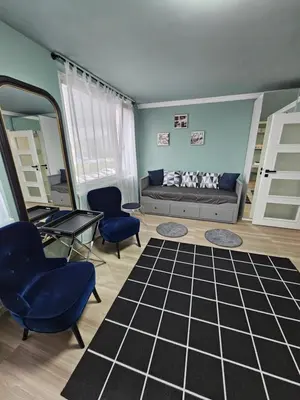 a living room with a couch and chairs and a mirror at Westfield apartment in Prague