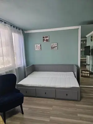 a bedroom with a bed and a chair at Westfield apartment in Prague