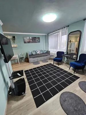 a living room with a couch and blue chairs at Westfield apartment in Prague