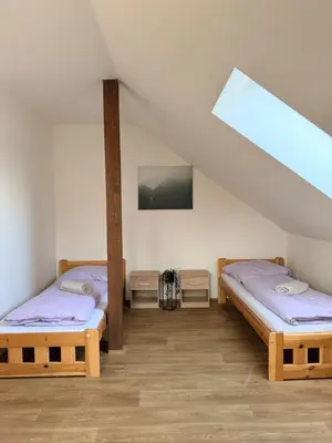 a room with two beds in a attic at Sleep & Go Czech Republic - Korycany in Neratovice