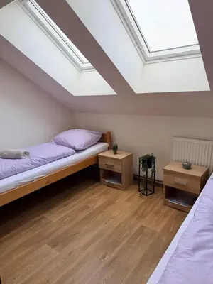 a bedroom with a bed and a skylight at Sleep & Go Czech Republic - Korycany in Neratovice