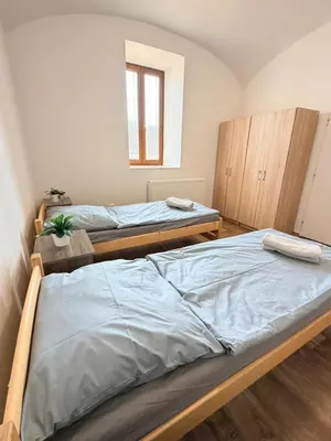 a bedroom with two beds and a mirror at Sleep & Go Czech Republic - Mořina in Mořina