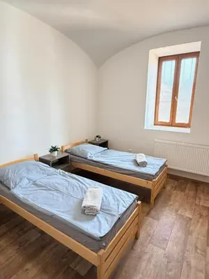 a room with two beds and a window at Sleep & Go Czech Republic - Mořina in Mořina